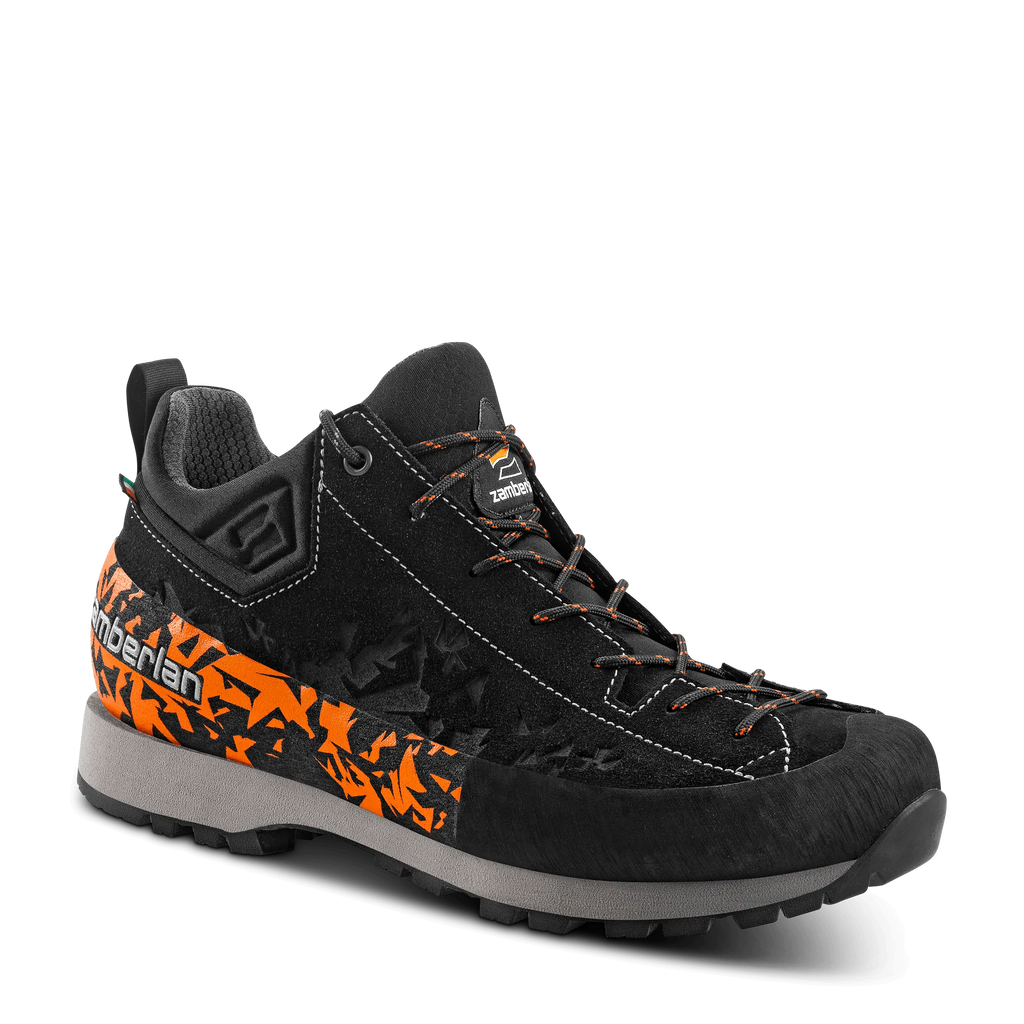 Black hiking boot with orange accents on a transparent background