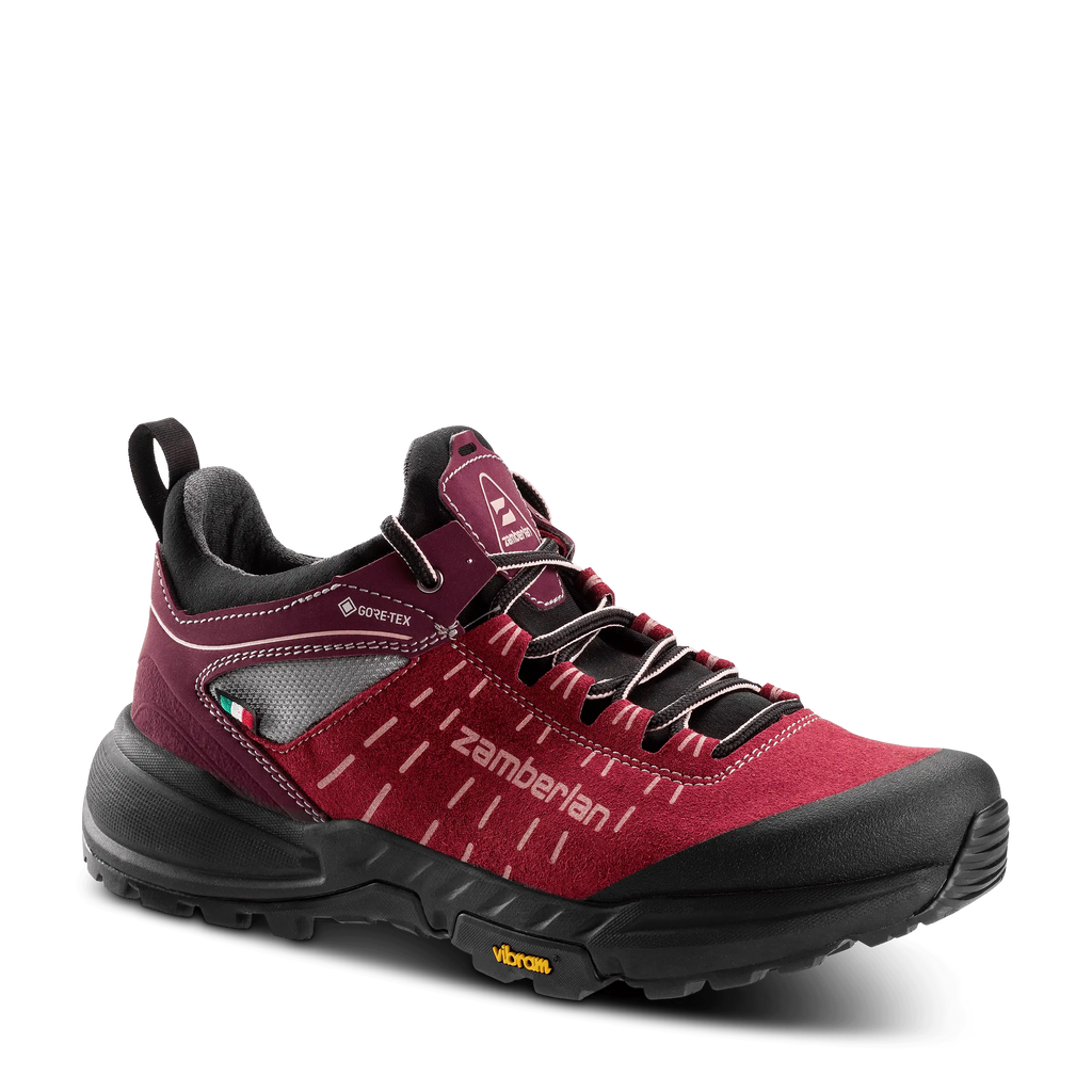 Red hiking shoe with black accents on a transparent background