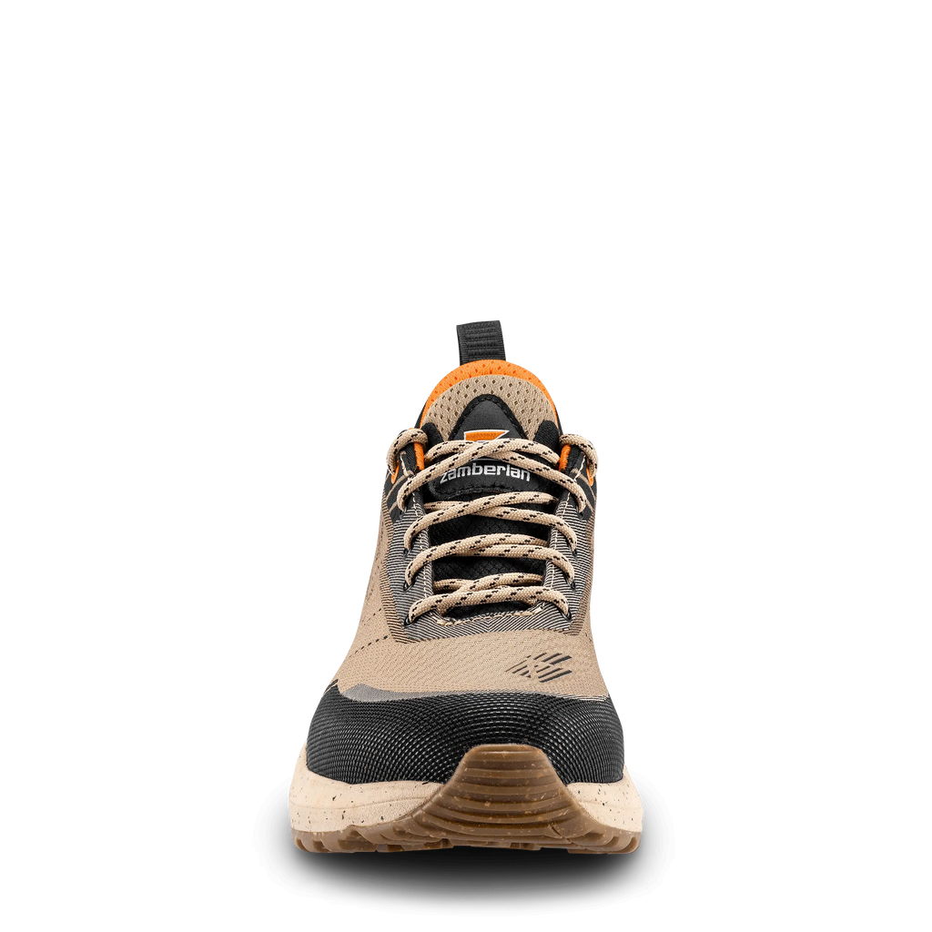 Tan and black hiking shoe with orange accents on a black background