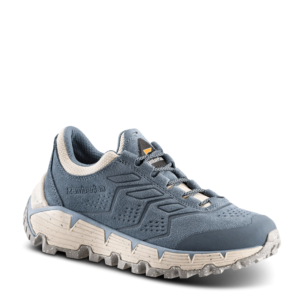 Blue hiking shoe with white sole on a black background