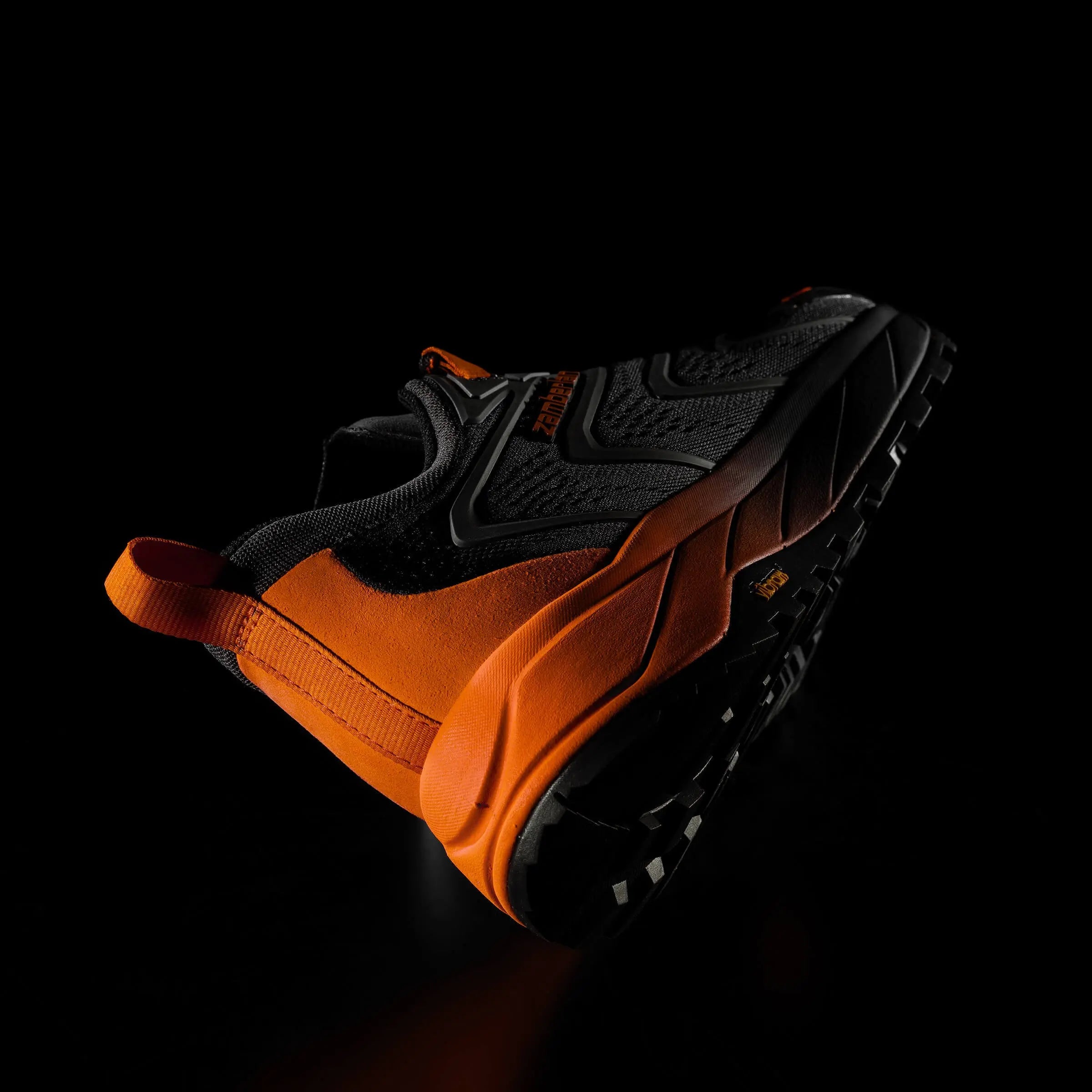 Black and orange sneaker on a black background