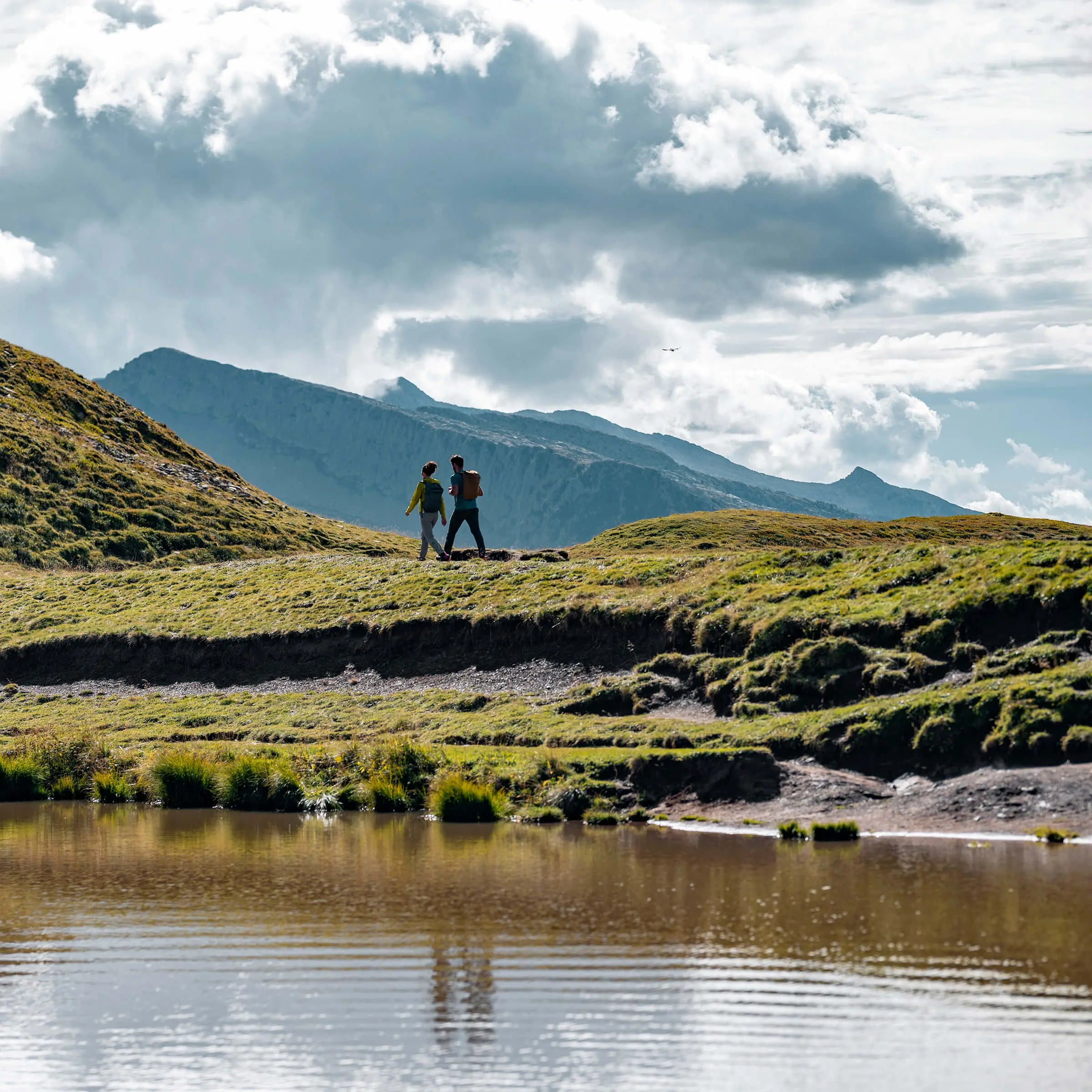 two hikers walking on a trail