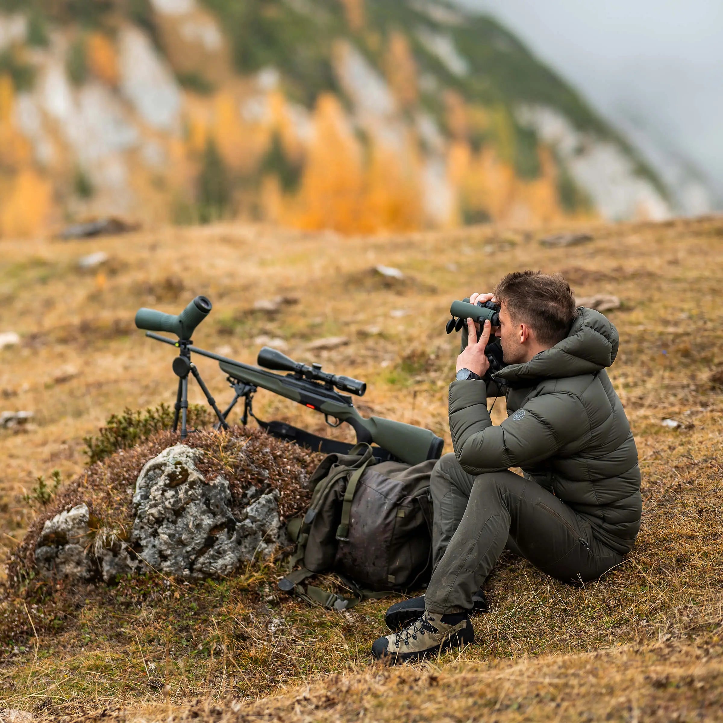 a hunter is sitting on the grass