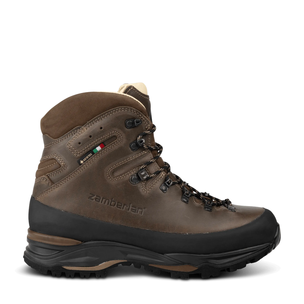 Brown hiking boot with black sole on a white background