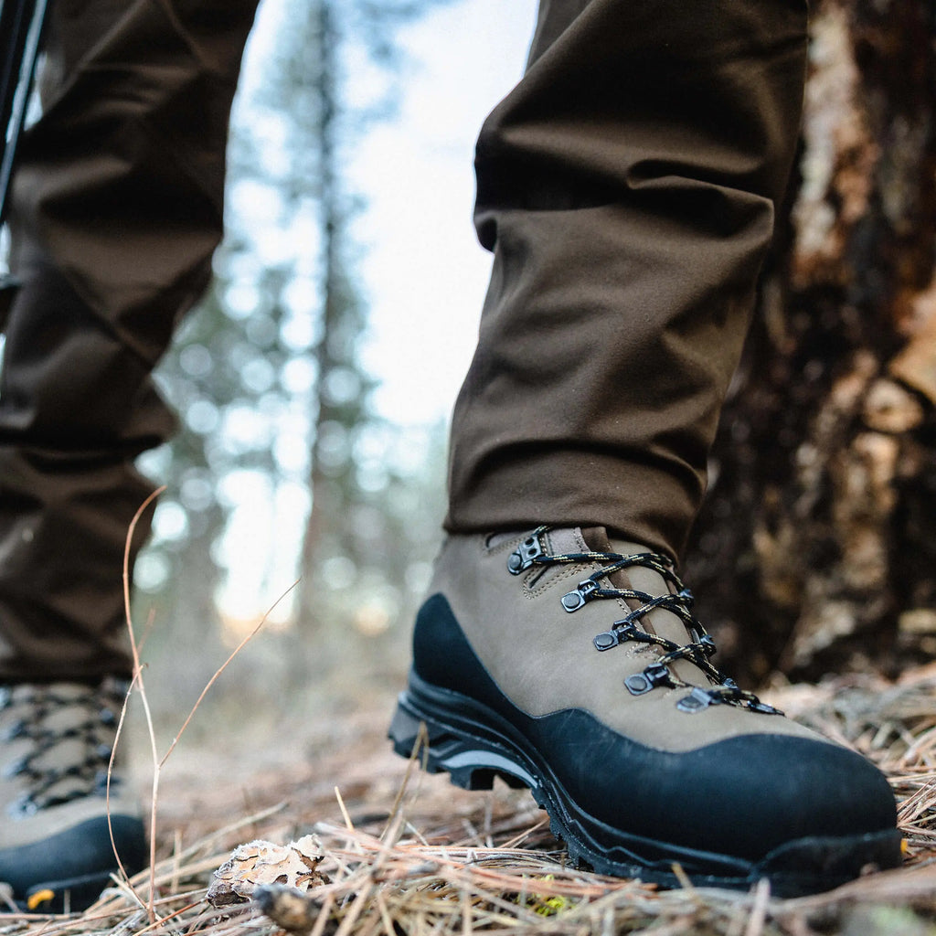 Hiking boots and pants in a forest setting