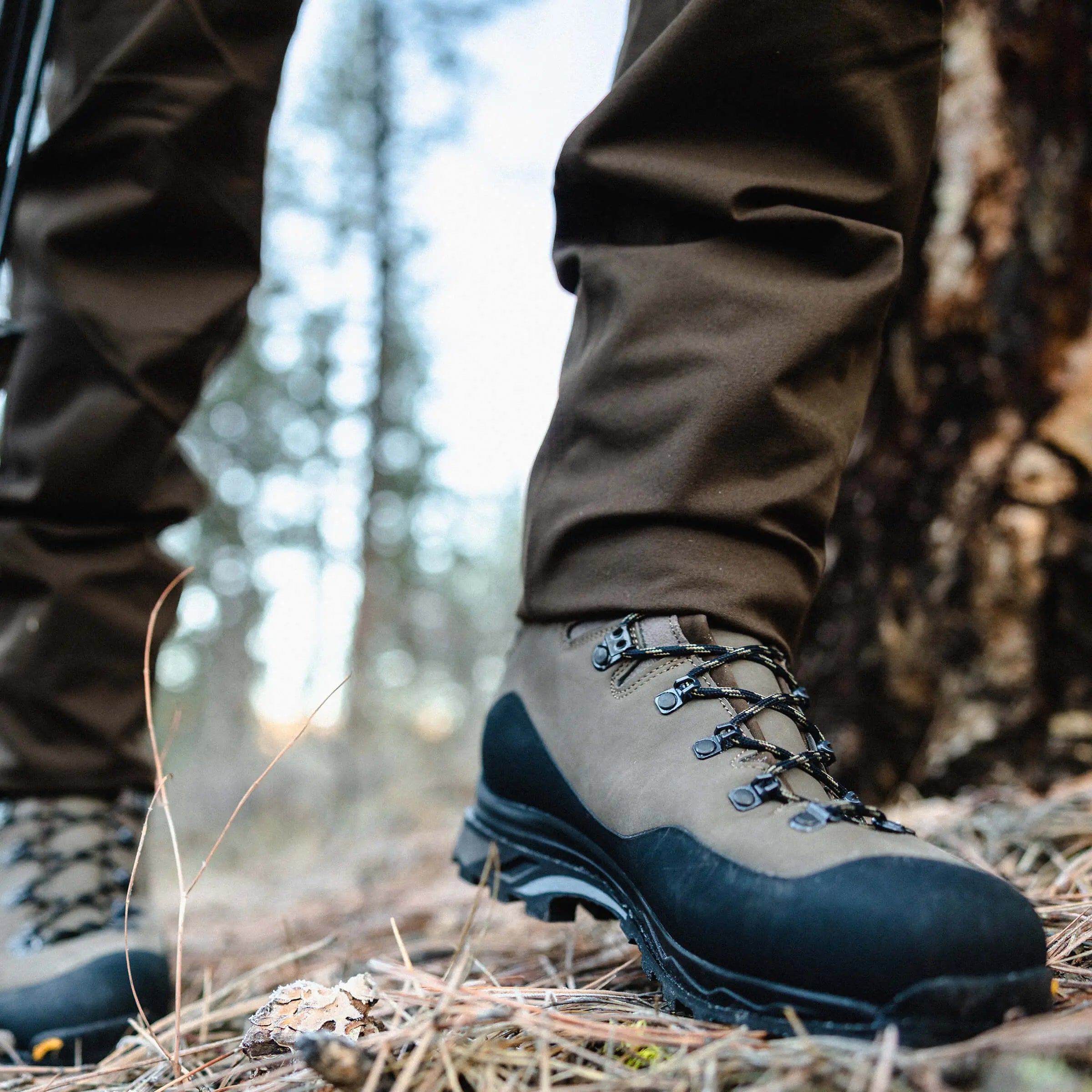 Hiking boots and pants in a forest setting