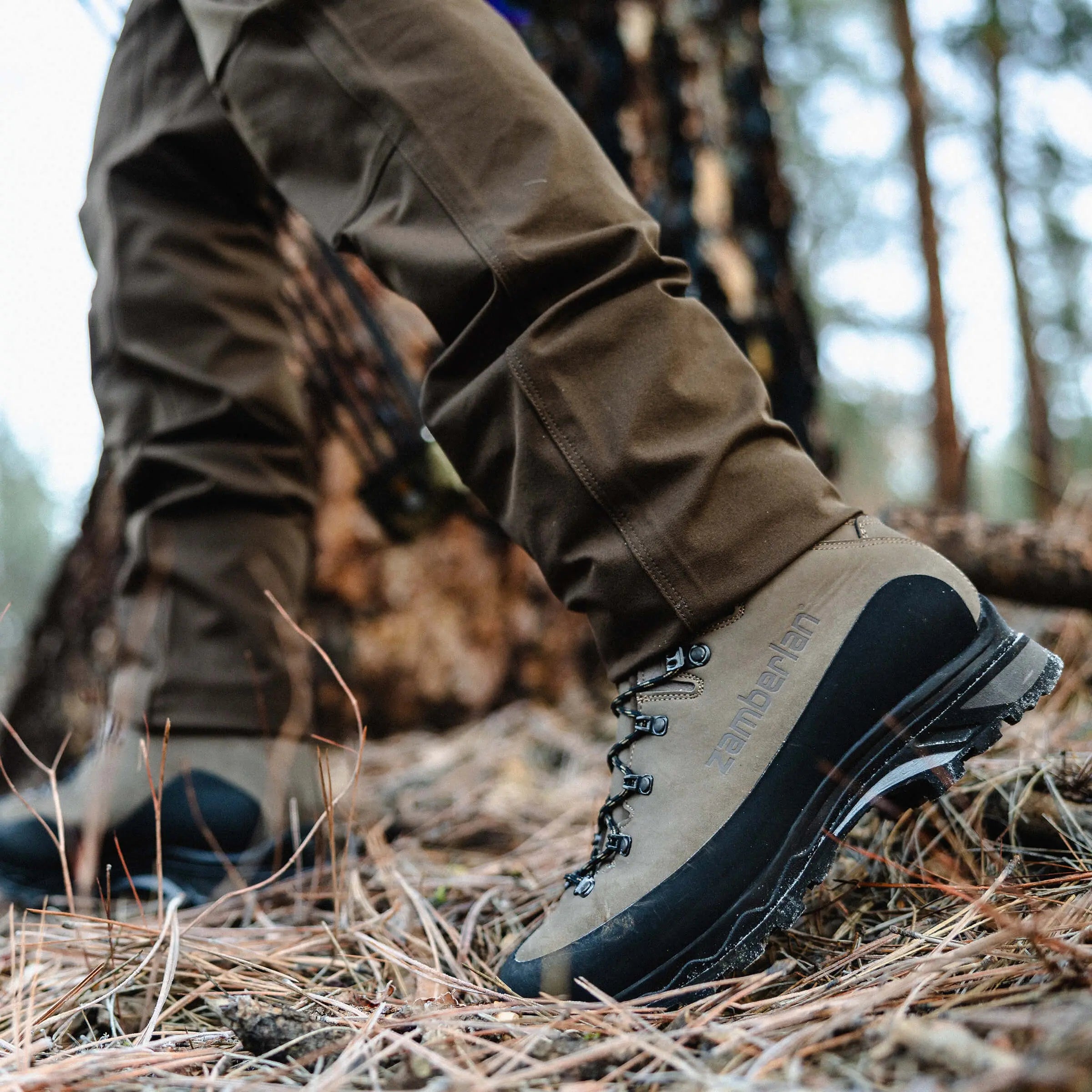 Brown hunting boot with black sole on a white background
