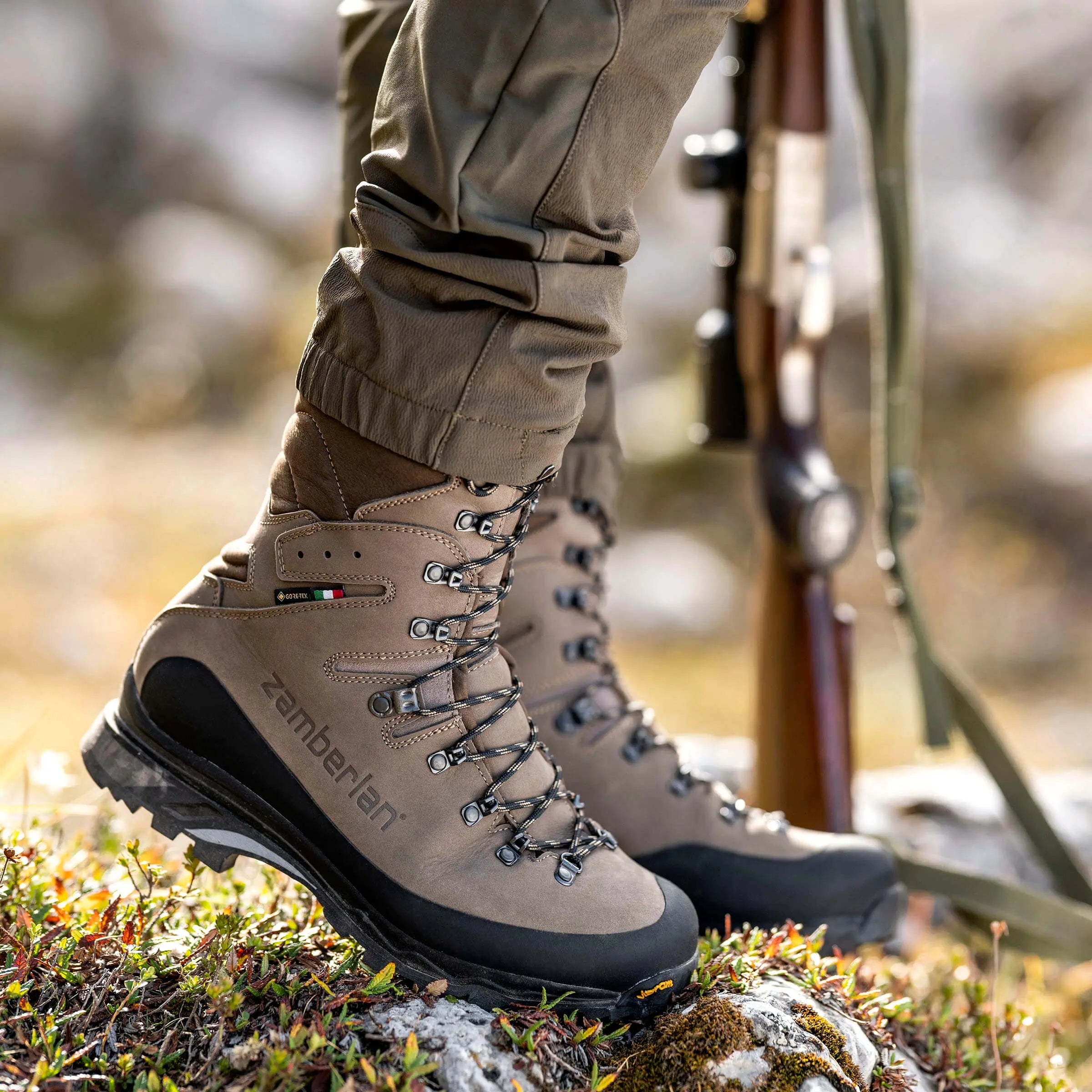 Close-up of beige hiking boots with black soles on a natural background