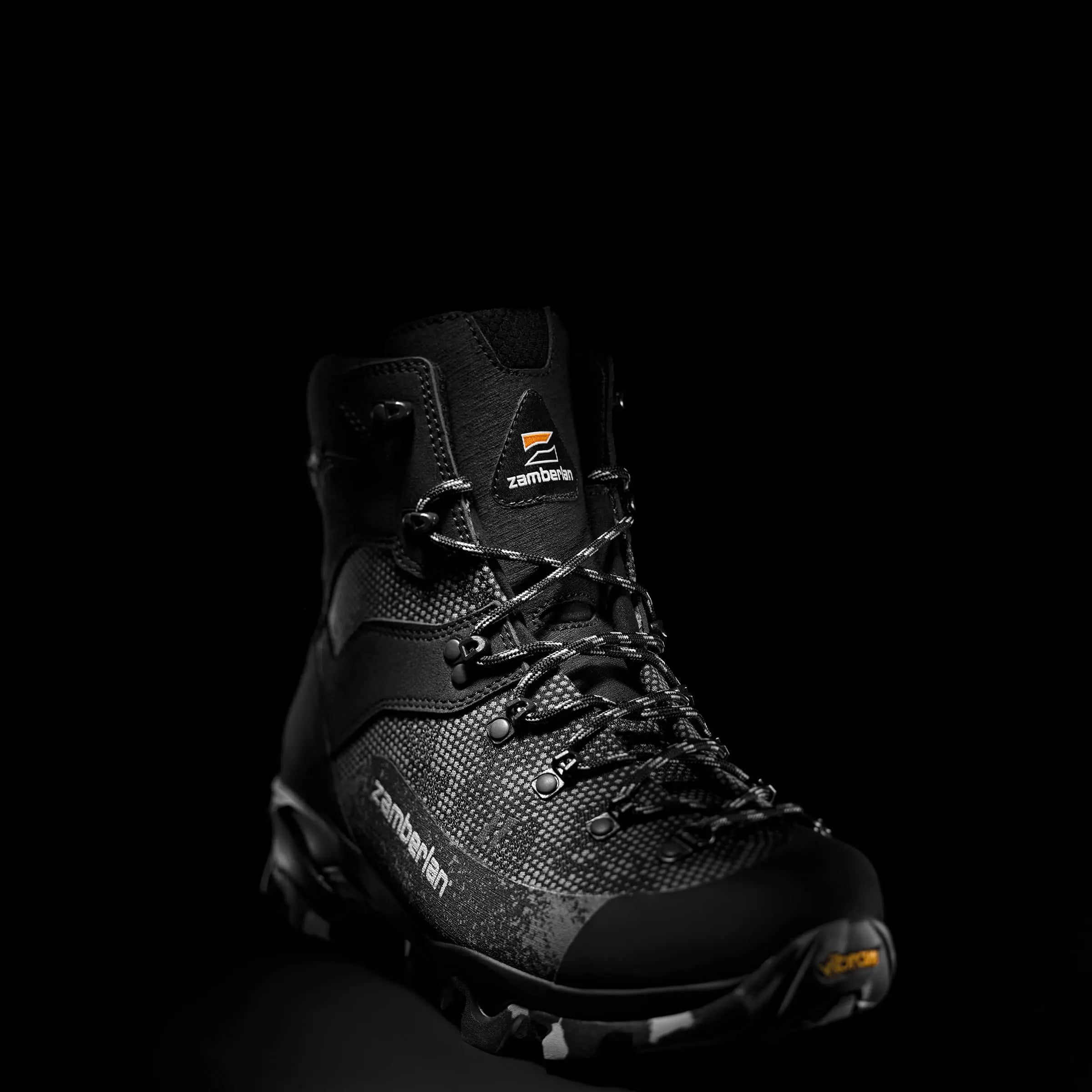 Black hiking boot with visible branding on a black background