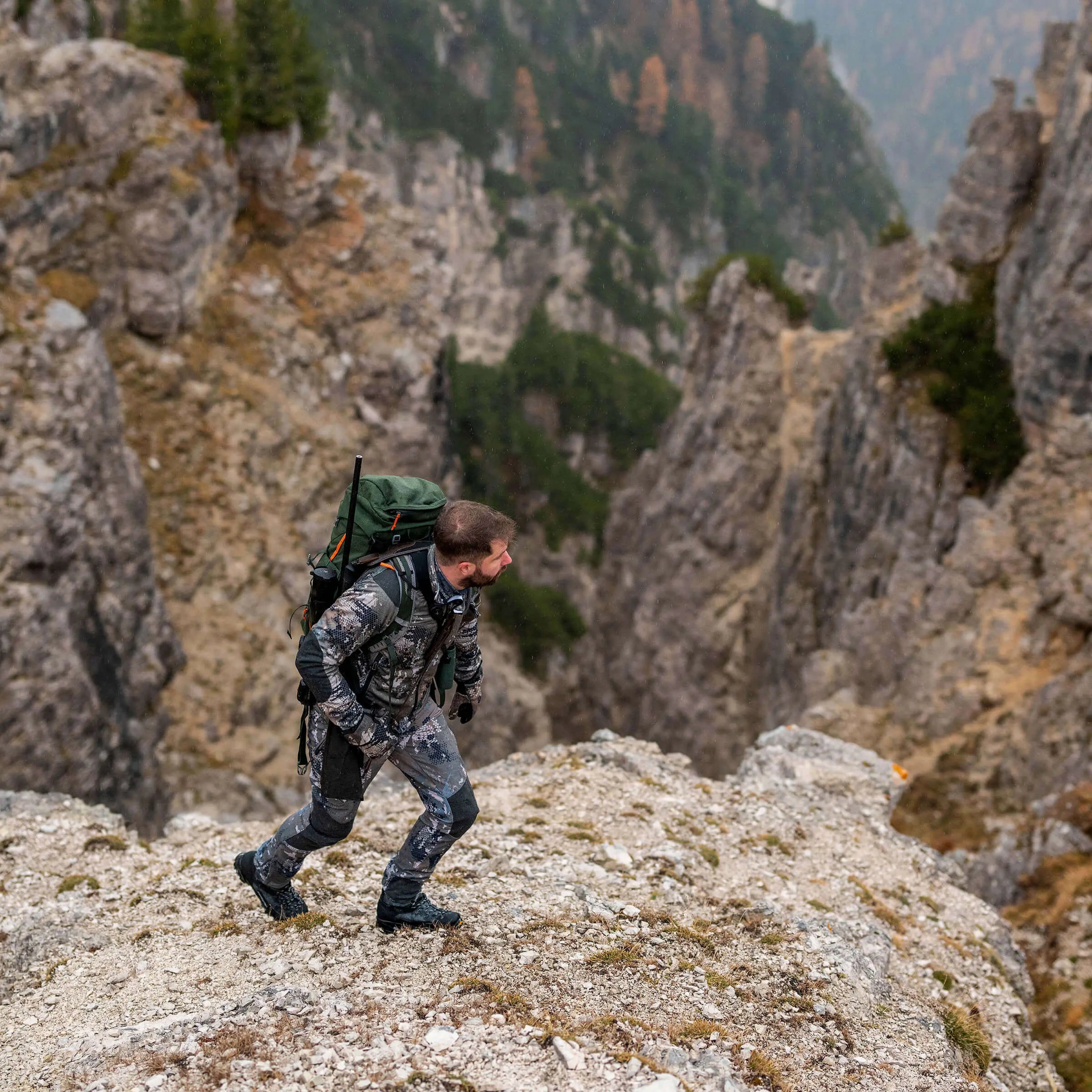 Person hiking on a rocky mountain trail with a backpack