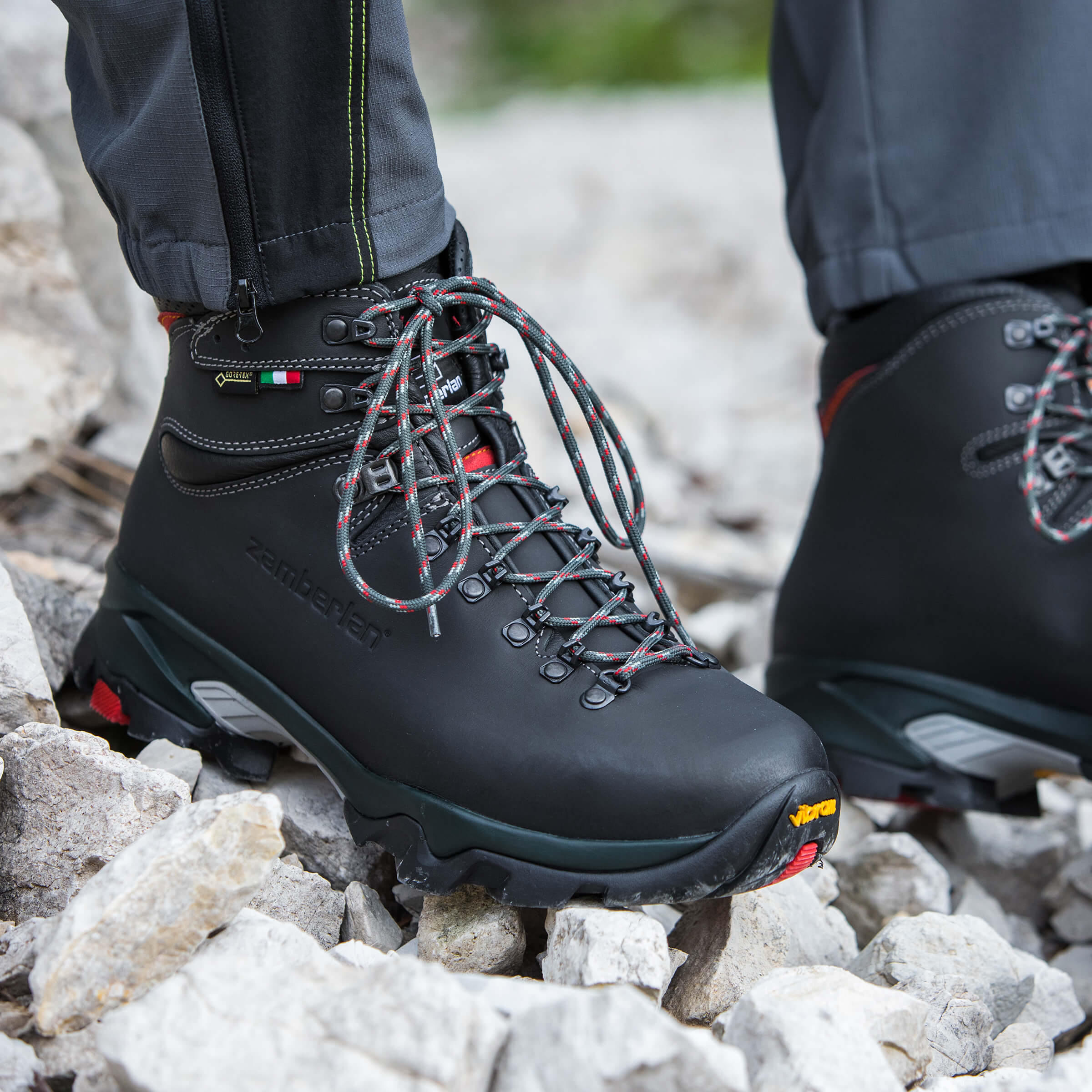 Black hiking boots on rocky ground