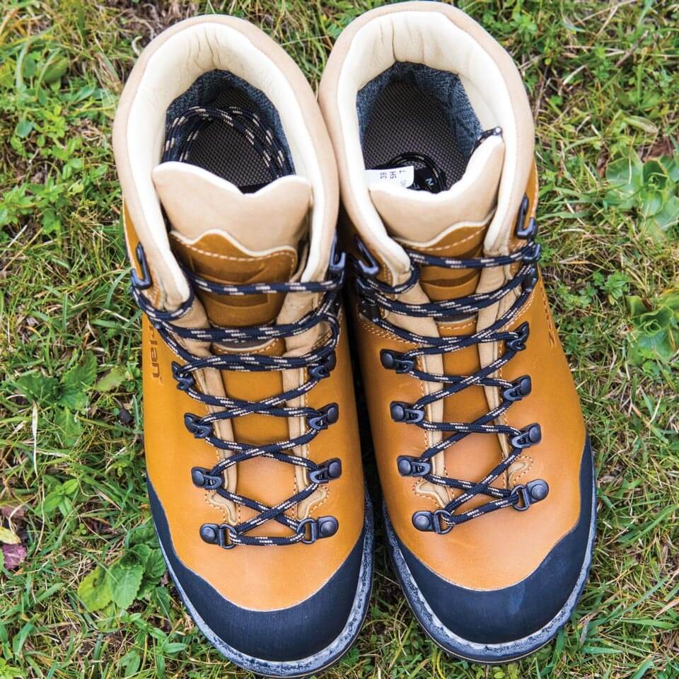 Pair of tan hiking boots on grass
