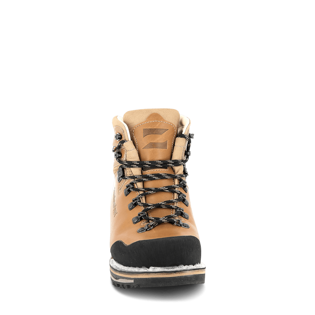 Tan hiking boot with black sole on a white background