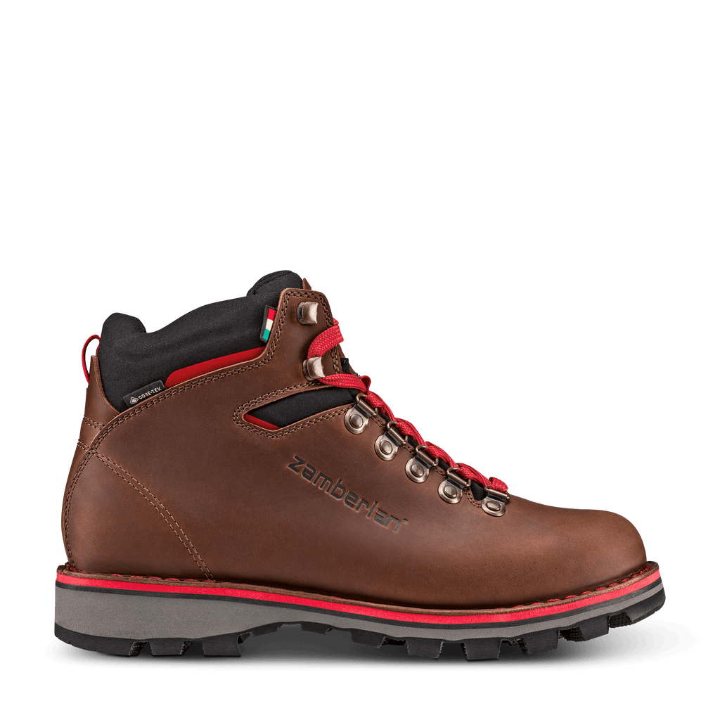 Brown hiking boot with red accents on a black background