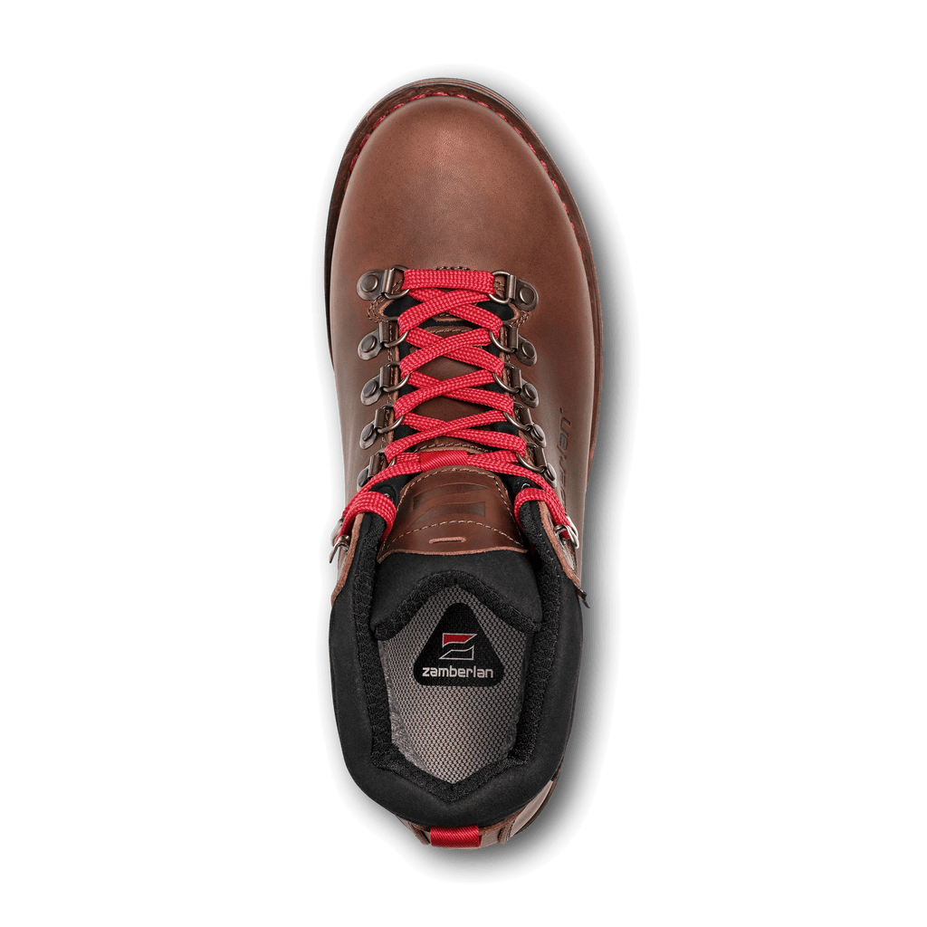 Brown hiking boot with red laces on a black background