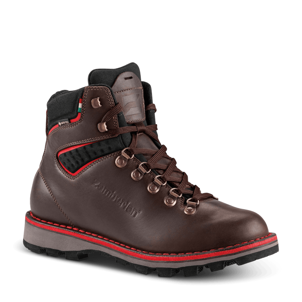 Brown hiking boot with red accents on a black background