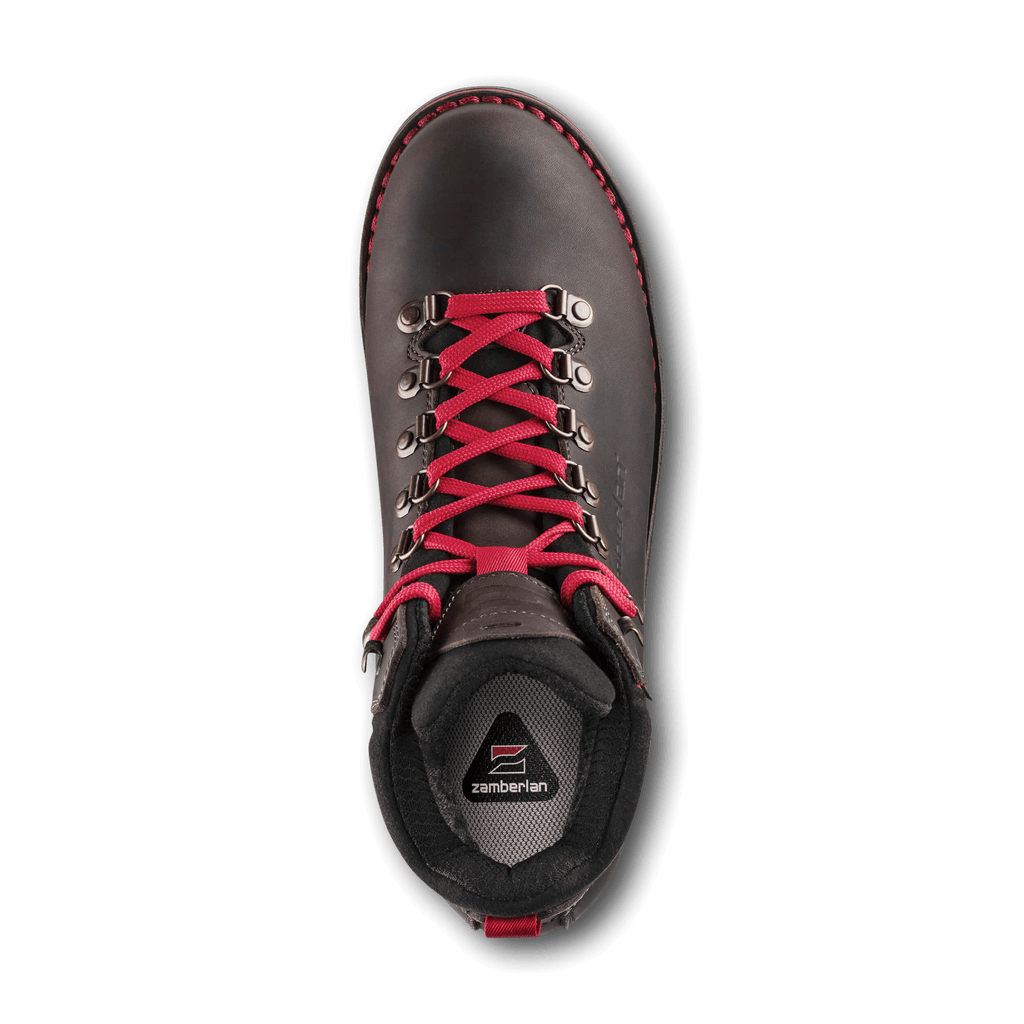 Black hiking boot with red laces on a black background