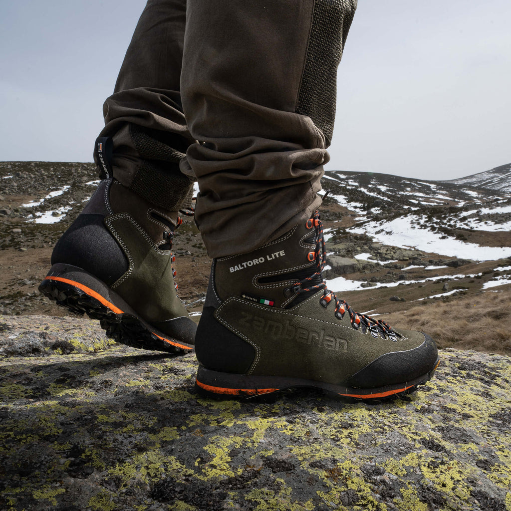 hunters wearing a pair of green boots