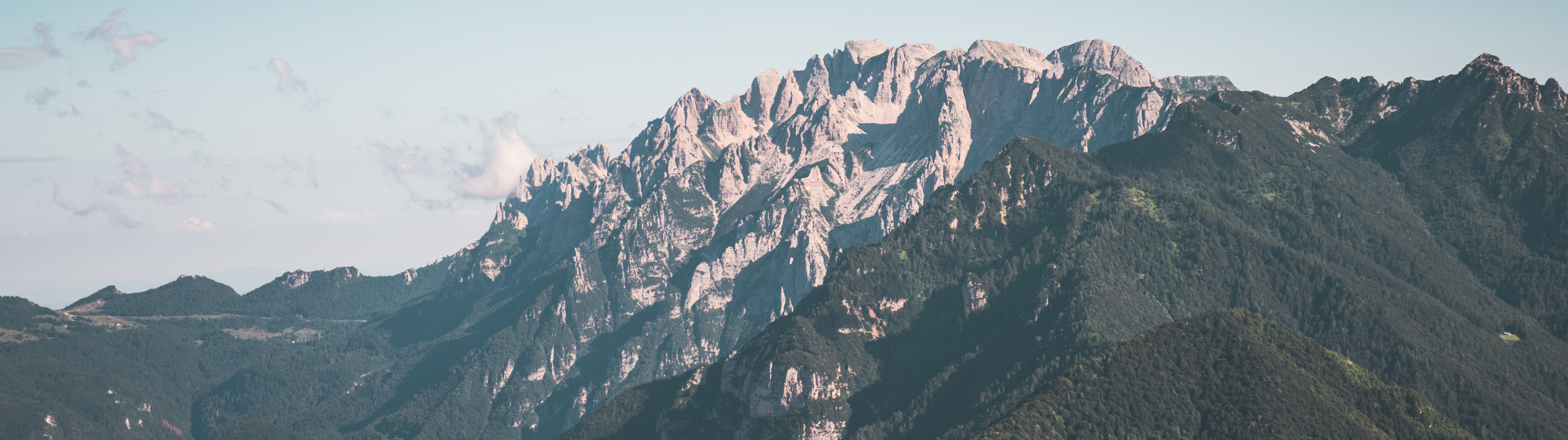 Mountain range with snow-capped peaks under a clear sky