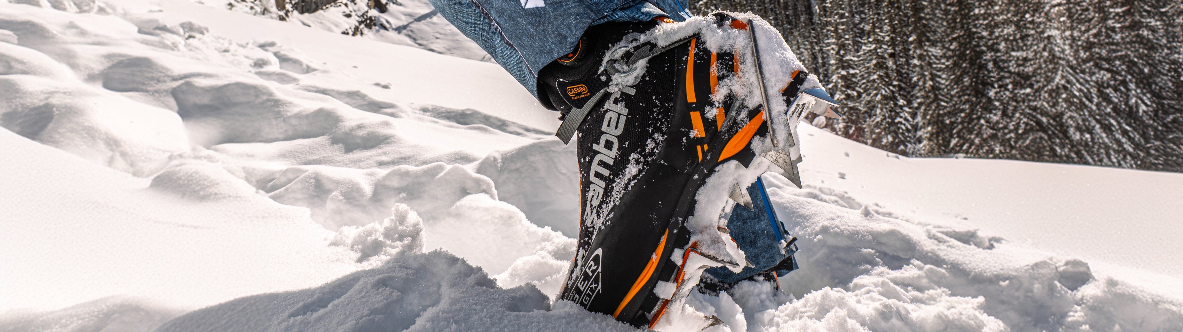 Person wearing a snowmobile suit with 'Arctic Cat' branding in a snowy landscape.